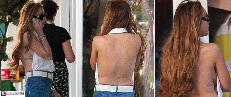Lindsay Lohan deixa parte do seio à mostra