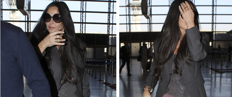Demi Moore tenta se esconder dos <I>flashes</i> em aeroporto