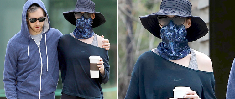 Anne Hathaway usa lenço para se esconder dos fotógrafos