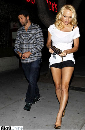 Pamela Anderson sai com um homem mais novo com blusa transparente