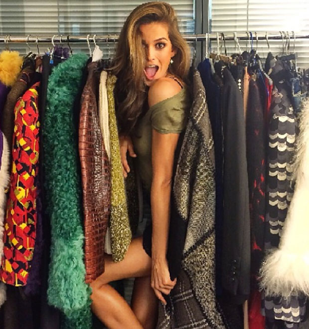 Izabel Goulart posa entre cabides de roupas na Espanha